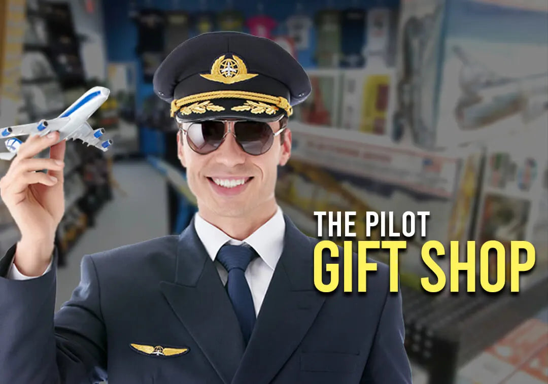 Smiling pilot with toy plane in pilot gift shop, Australia.